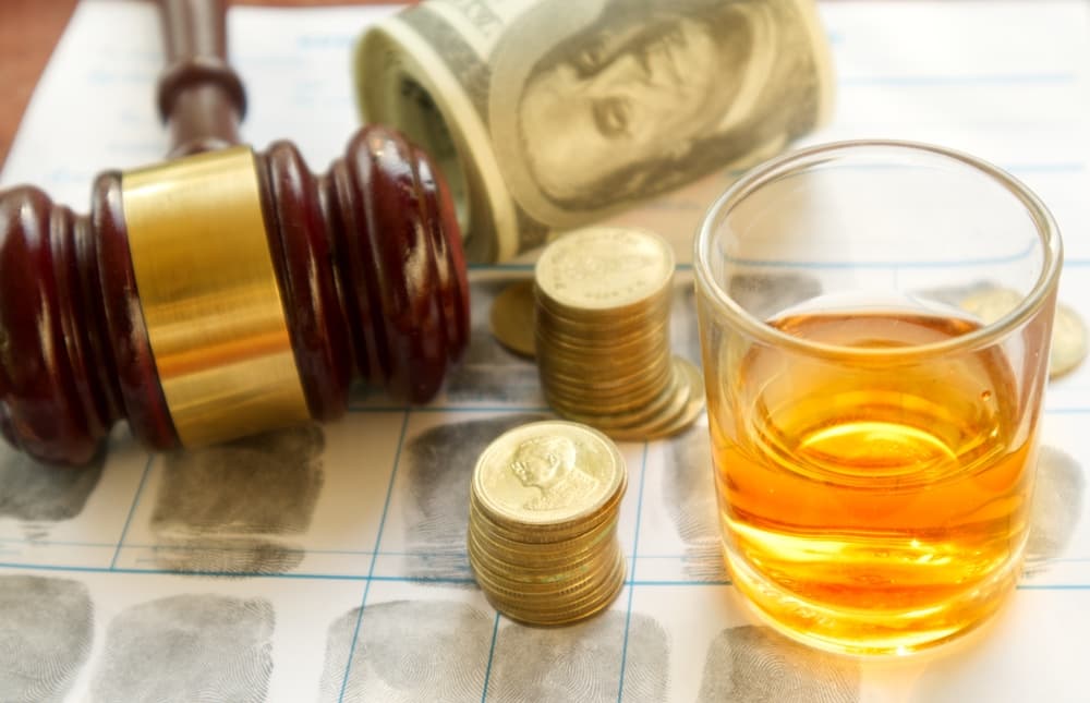 Glass of whiskey on fingerprint crime page file.
