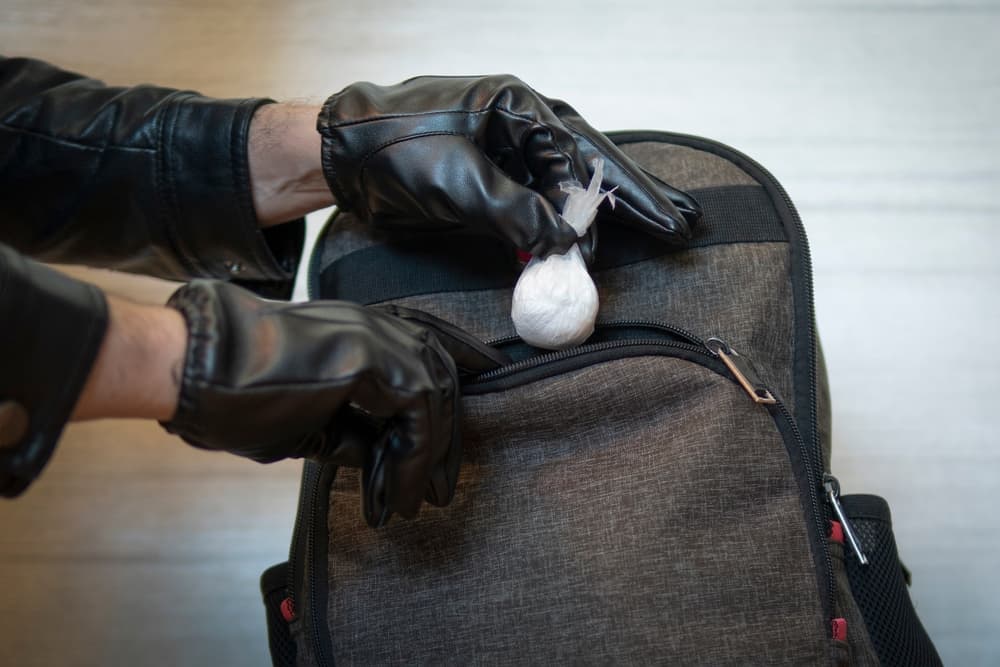 A police officer searches a drug dealer.