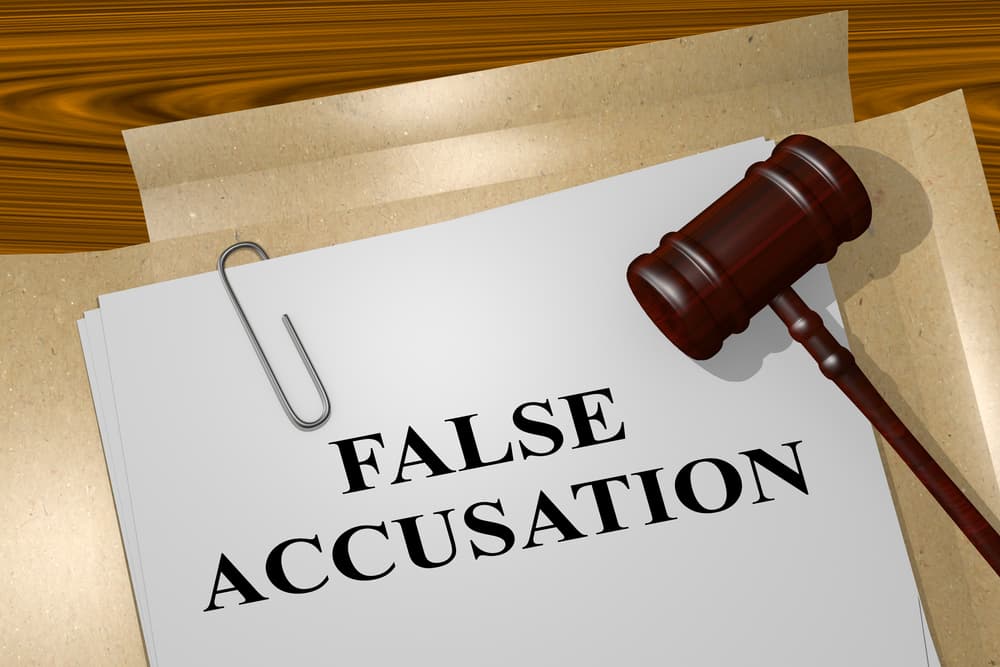 3D illustration of "FALSE ACCUSATION" title on Legal Documents.